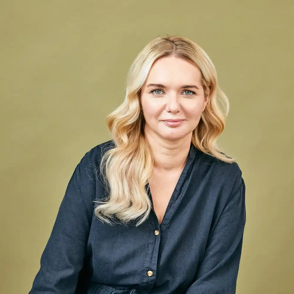 Blonde woman in dark blue shirt.