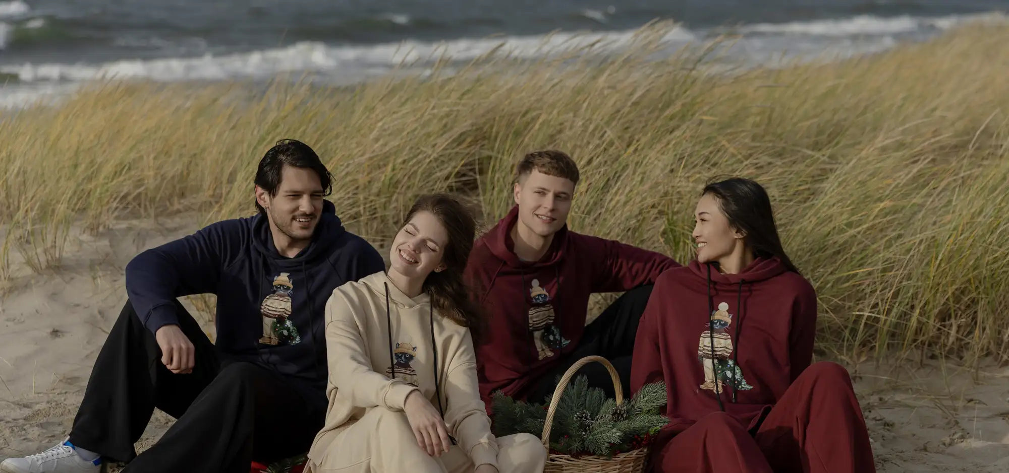 Maroon hoodie with holiday design and hood, made of fleece material.