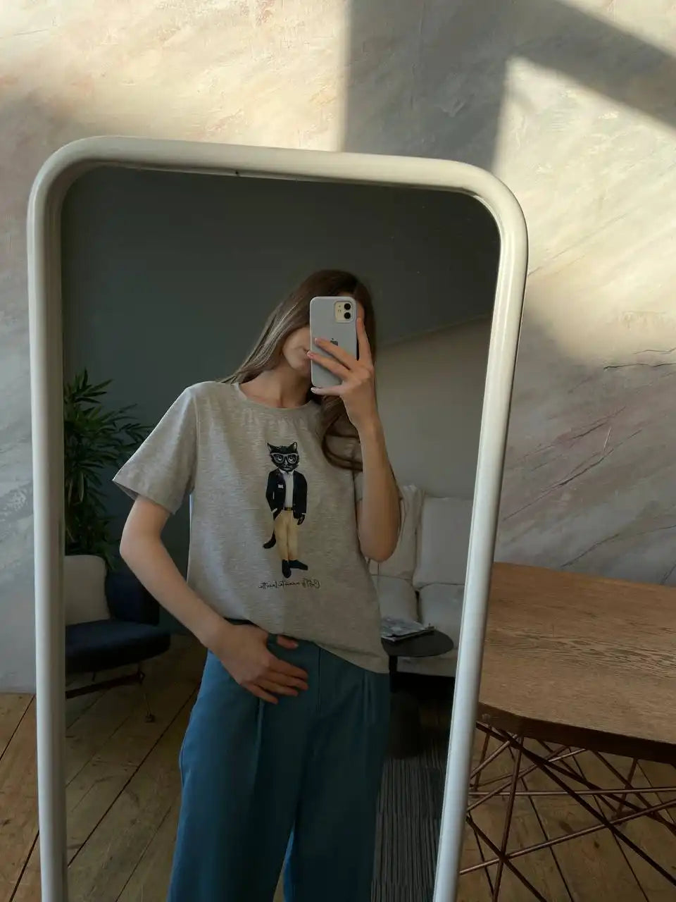 Woman in mirror taking selfie.
